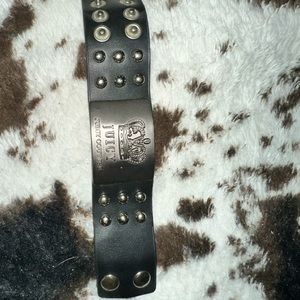 Women’s juicy couture snap on bracelet, it is black.